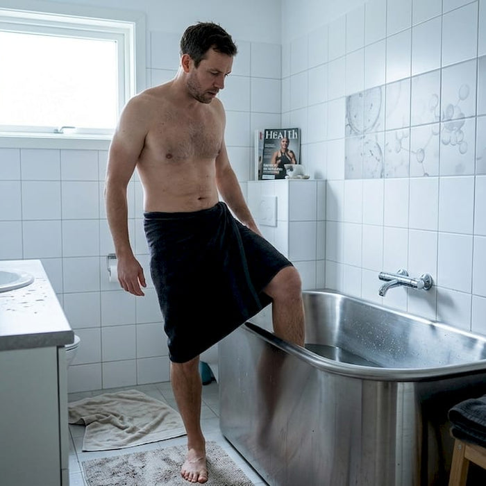 Man entering cold plunge tub for recovery