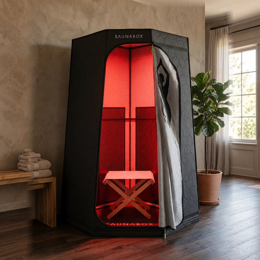 Saunabox Pulse Pro infrared sauna with its red interior panels in a home room